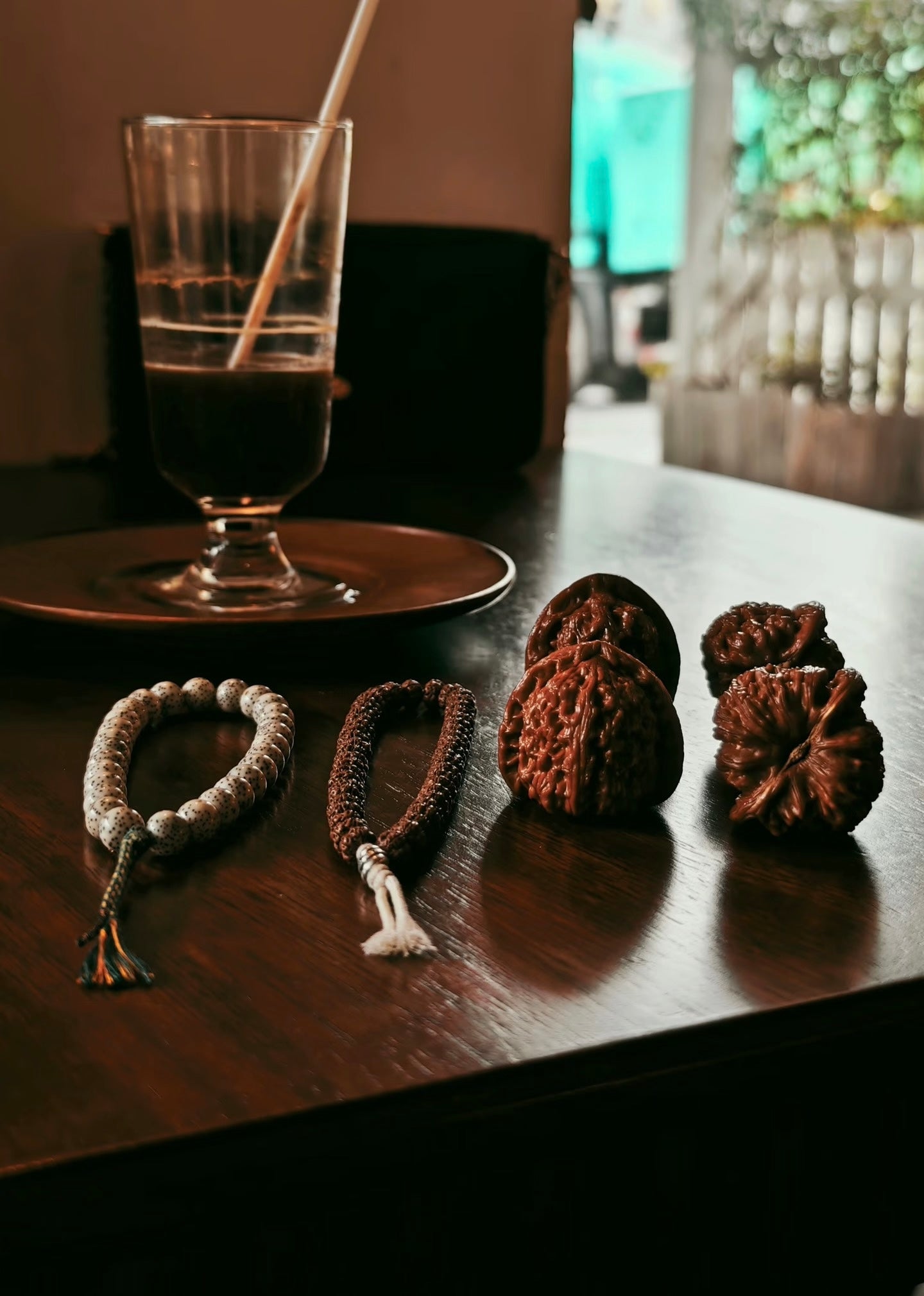 Real walnuts among everyday objects on a sunlit wooden table