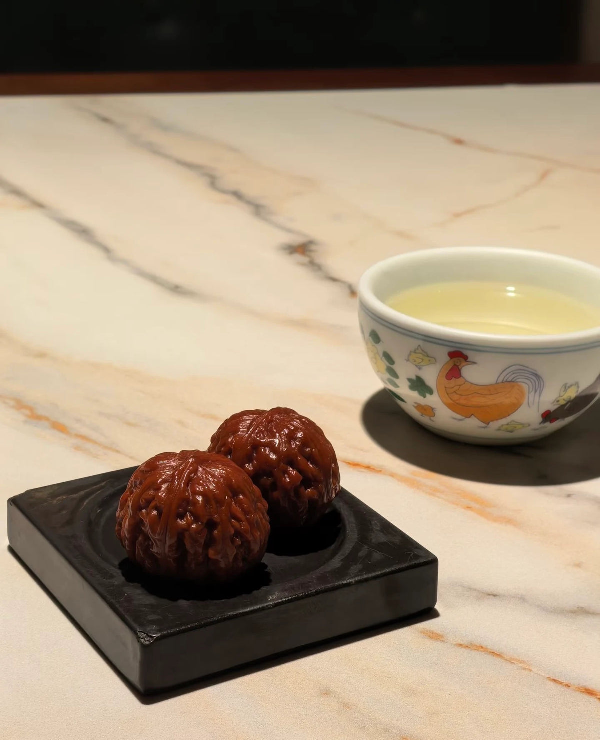 Wenwan walnuts beside a tea setting.